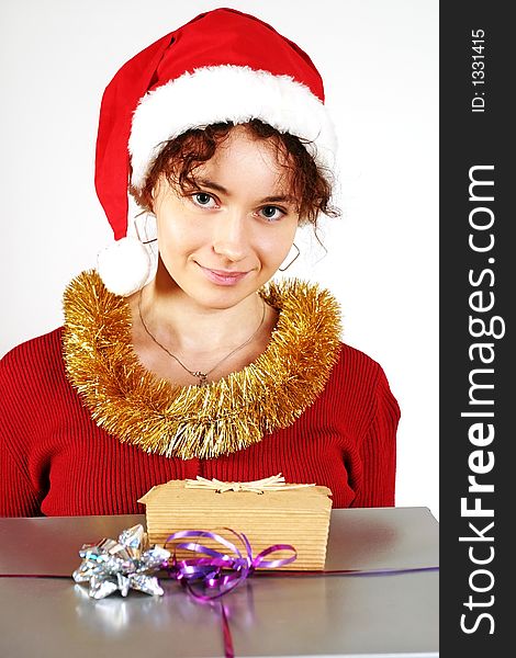 Young woman in a red and white santa fancy hat with presents. Young woman in a red and white santa fancy hat with presents