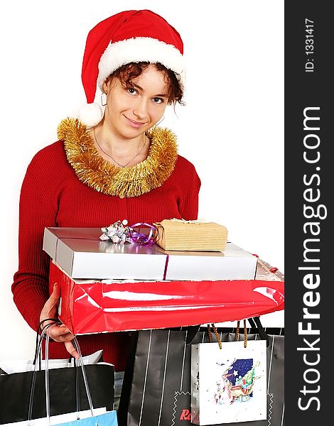 Young woman in  a red and white santa fancy hat with presents. Young woman in  a red and white santa fancy hat with presents