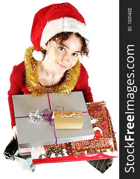 Young woman in  a red and white santa fancy hat with presents. Young woman in  a red and white santa fancy hat with presents