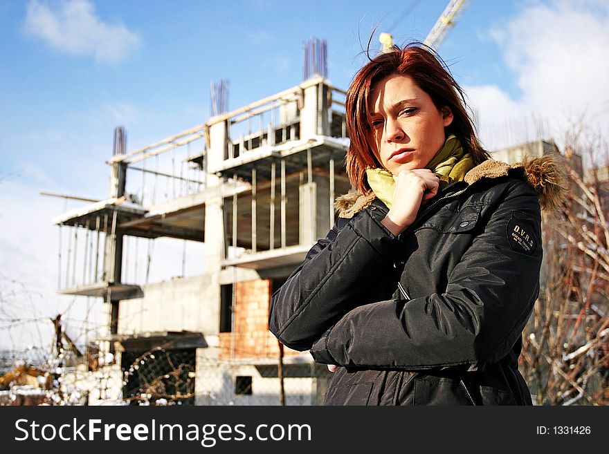 Girl, young woman at a building site- thinking. Girl, young woman at a building site- thinking