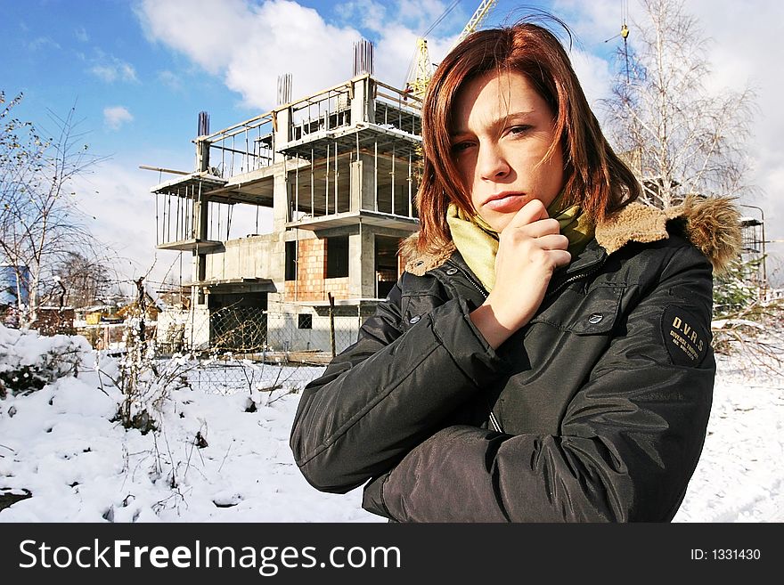 Girl, young woman at  a building site- thinking
