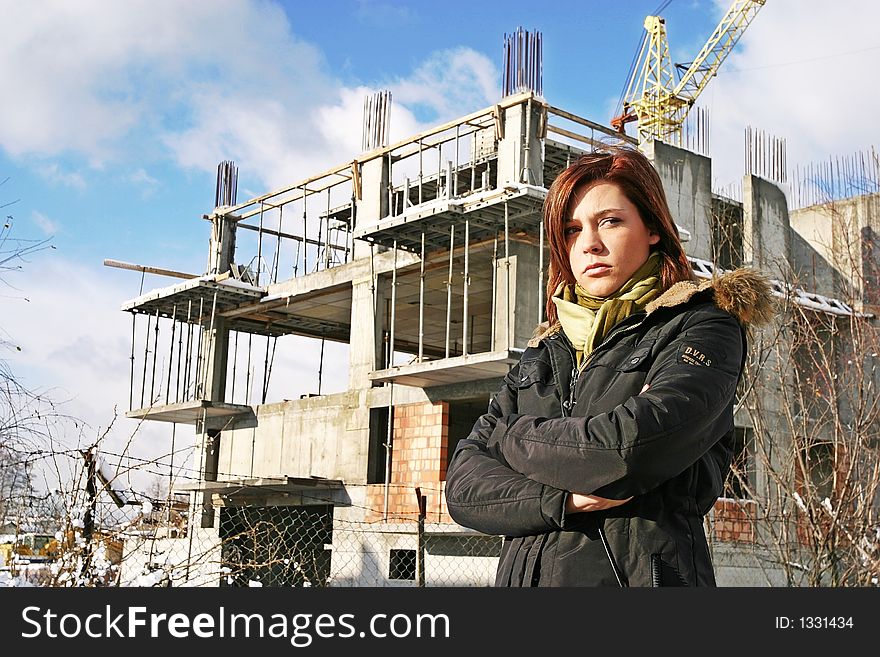 Girl, young woman at  a building site- thinking