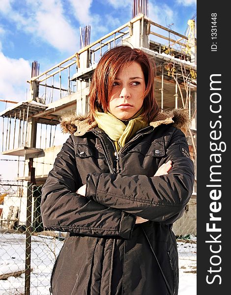 Girl, young woman at  a building site- thinking