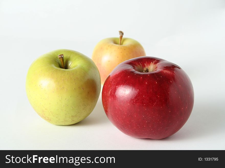 Juicy fresh apples separately from a background with drops of water on a leather