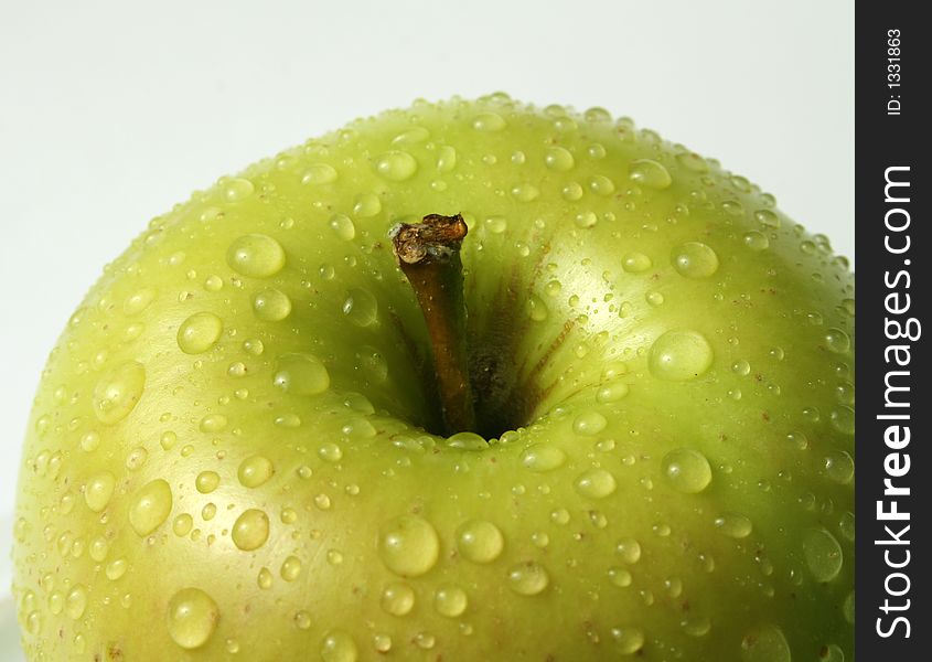 Juicy fresh apples separately from a background with drops of water on a leather