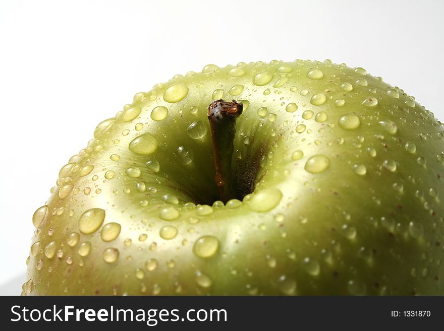 Juicy fresh apples separately from a background with drops of water on a leather