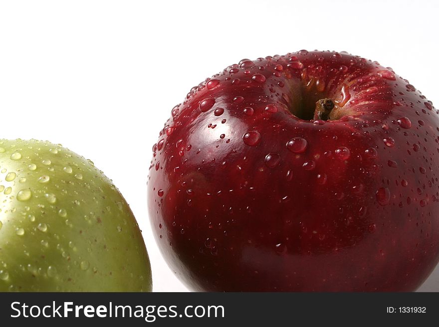 Juicy fresh apples separately from a background with drops of water on a leather