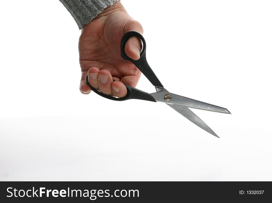 A man's hand holding open scissors. A man's hand holding open scissors