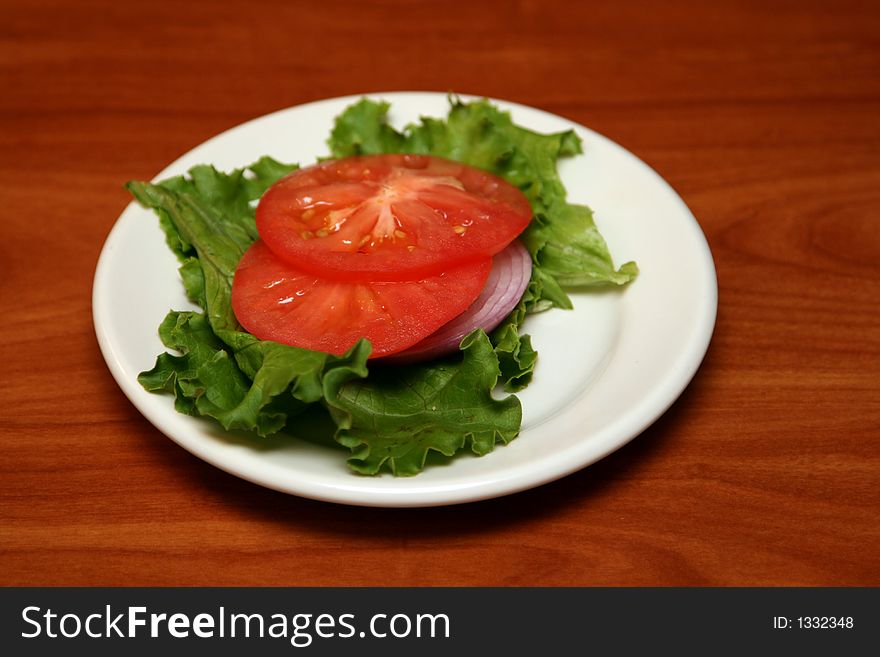 Tomato slices on salad leaves. Tomato slices on salad leaves