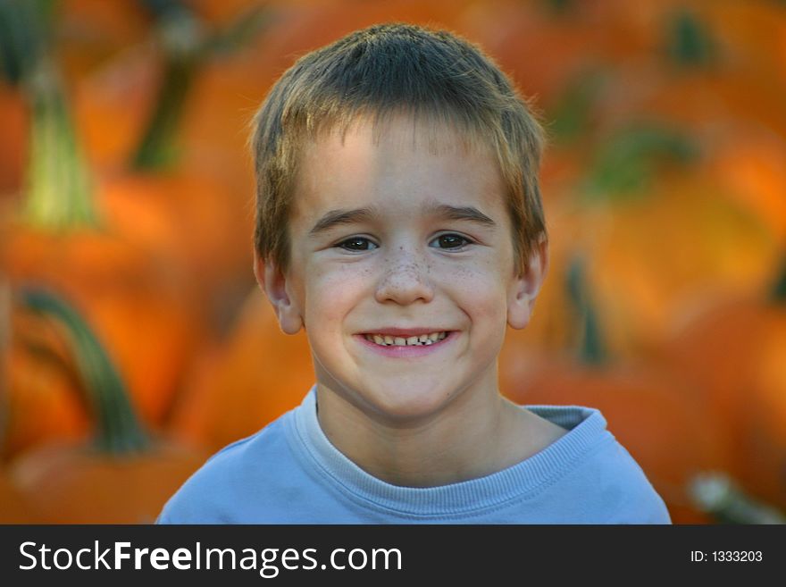 Boy smiling with a pumpkin background