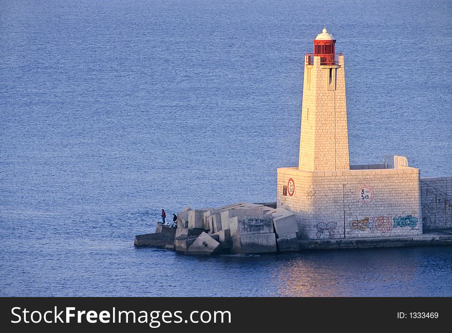 Beacon at sunrise in the entrance of Nice port in french riviera, europe. Beacon at sunrise in the entrance of Nice port in french riviera, europe