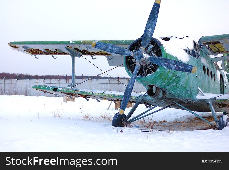 Broken abandoned aircraft in the snow