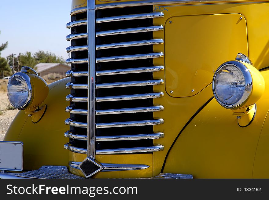 Close up of the front end of a yellow truck