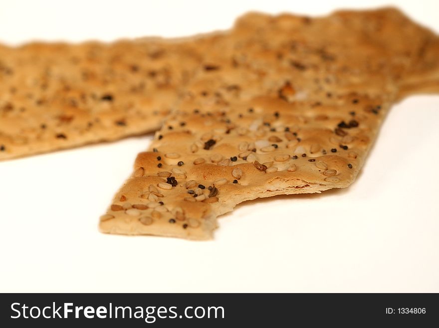 Close up of Seeded flat crackers with bite taken out in corner