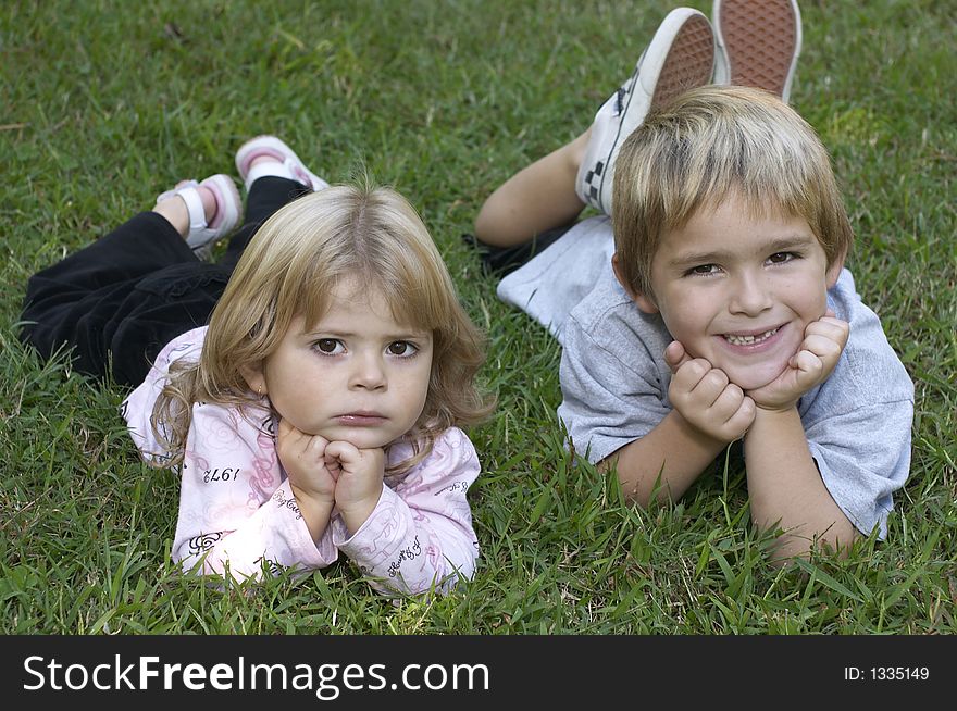 Two kids relaxing on grass. Two kids relaxing on grass