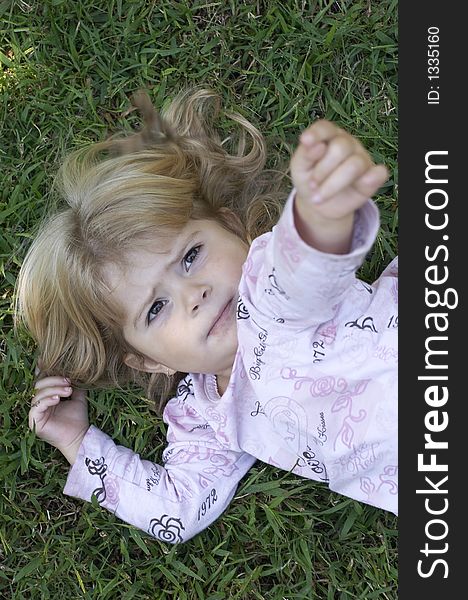 Young girl on grass with arm in air