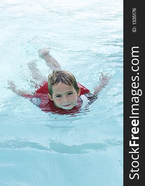 Young boy swimming in pool