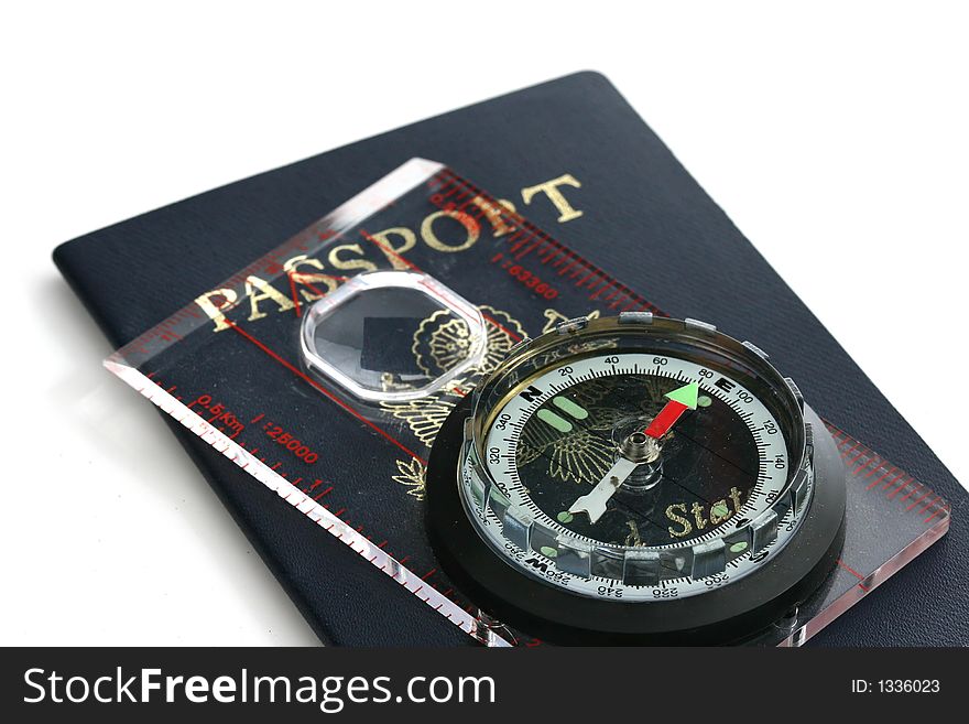 A passport with compass on white space suggesting travel. A passport with compass on white space suggesting travel