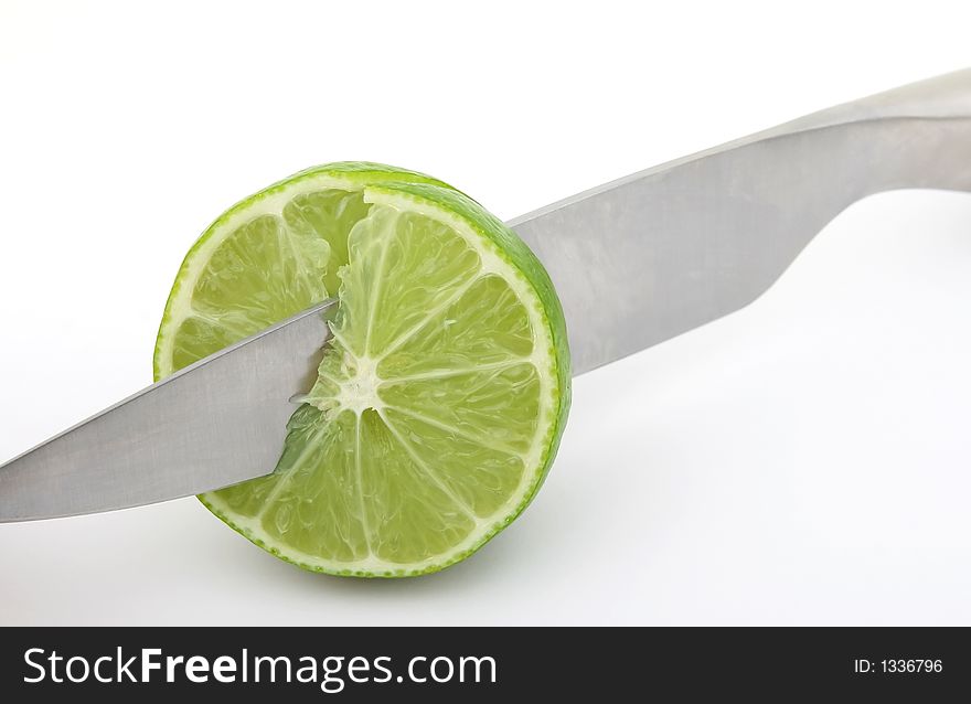 Fresh fruit, a tropical green lemon macro closeup, isolated on white, close-up with copyspace. Fresh fruit, a tropical green lemon macro closeup, isolated on white, close-up with copyspace