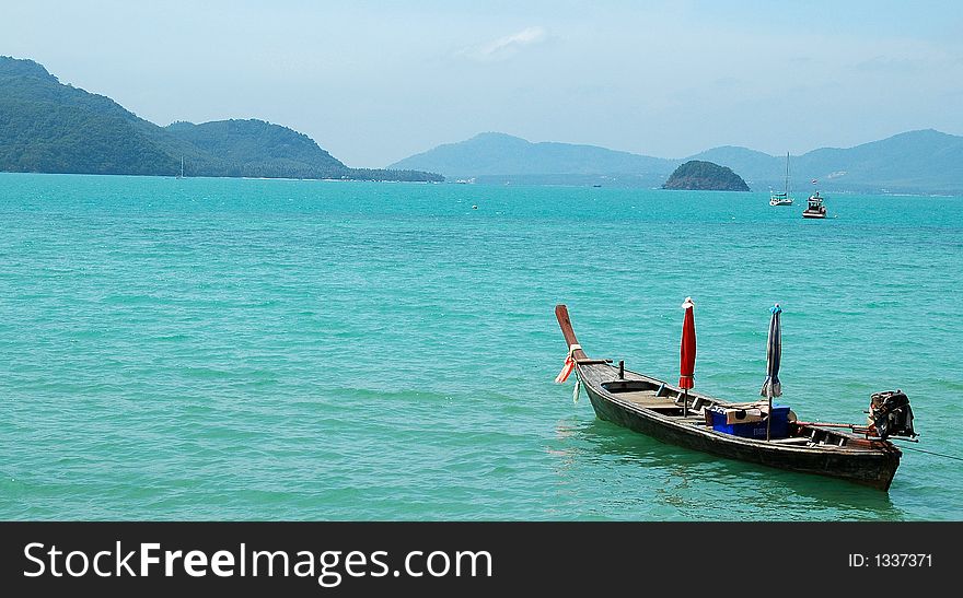 Shot of a boat in the sea from a Thailand shore. Shot of a boat in the sea from a Thailand shore.