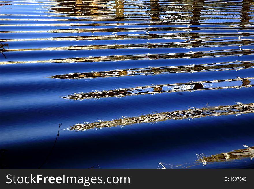 Wavy water with reflections.Blue water. Wavy water with reflections.Blue water.