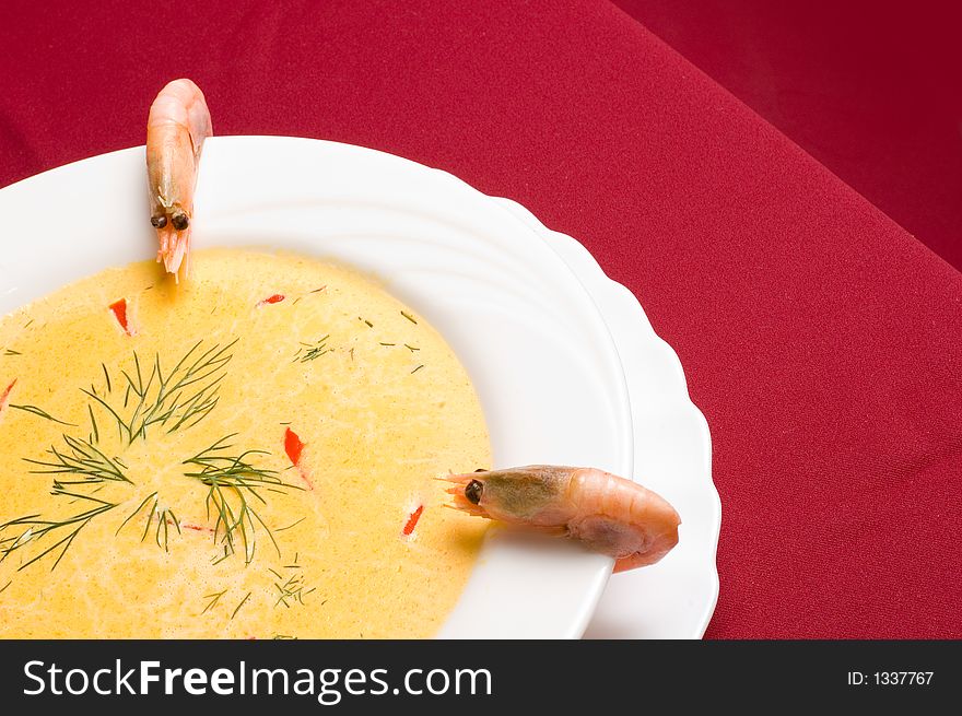 Think shrimp soup with shrimp decorations over royal red background. Think shrimp soup with shrimp decorations over royal red background