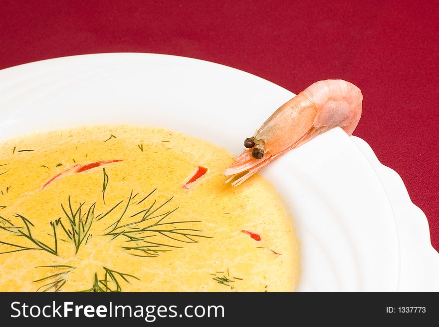 Think shrimp soup with shrimp decorations over royal red background. Think shrimp soup with shrimp decorations over royal red background