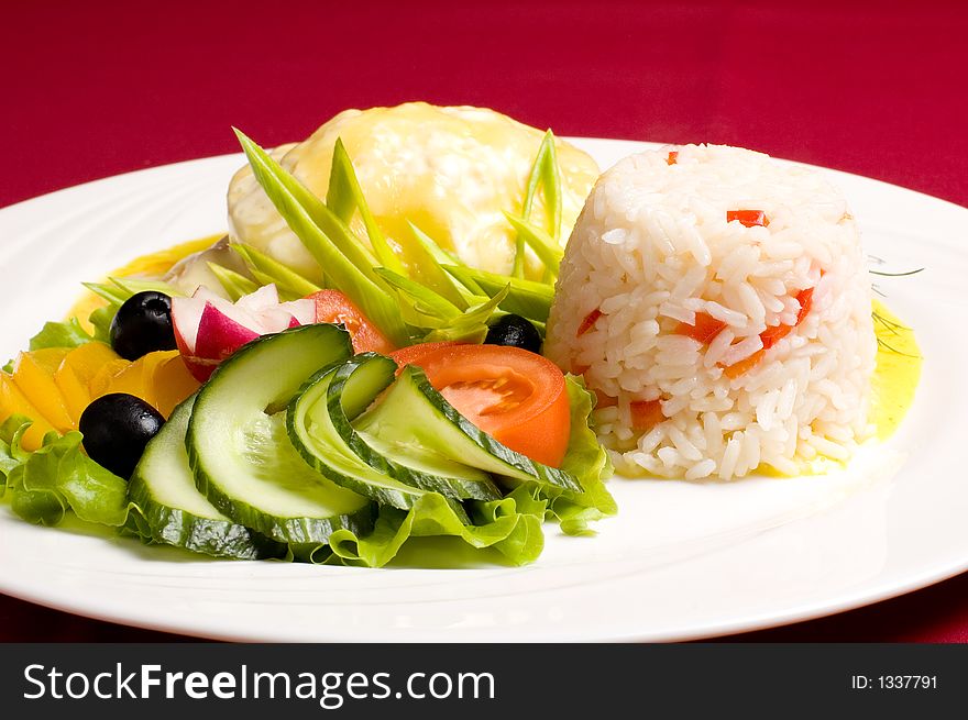 GratinÃ©ed chicken meat with rice and fresh olives peach tomato cucumber and radish. GratinÃ©ed chicken meat with rice and fresh olives peach tomato cucumber and radish