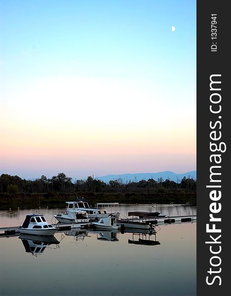 Lake mole with clear blue ad peacefully water. Couple of boats. Lake mole with clear blue ad peacefully water. Couple of boats.