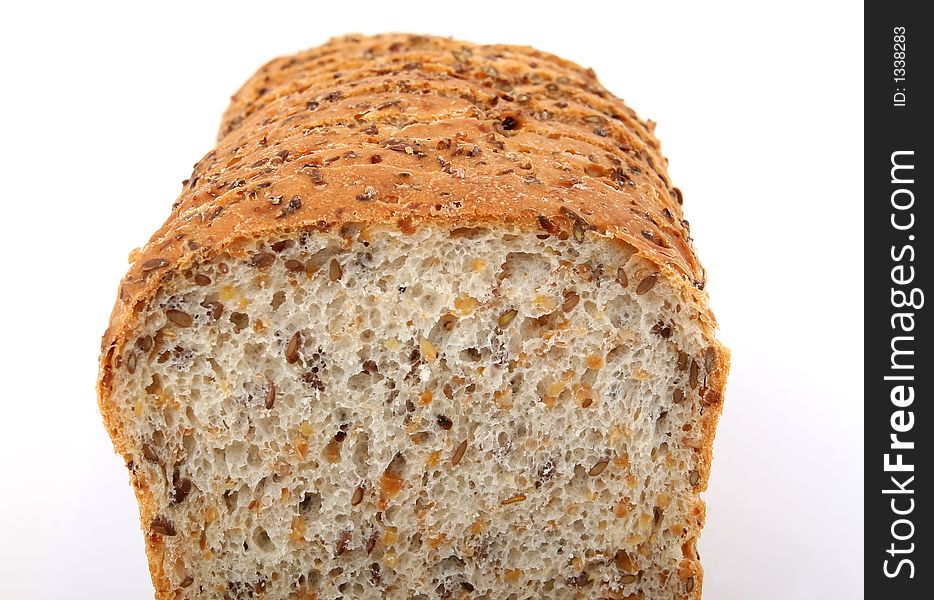 Loaf of sliced brown bread, isolated on white, macro over white. Loaf of sliced brown bread, isolated on white, macro over white