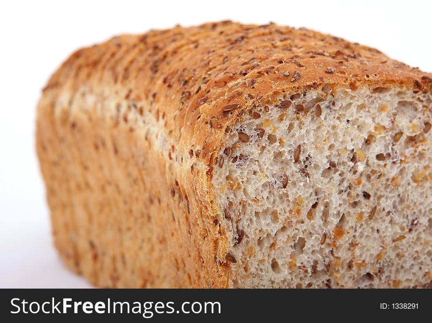 Loaf of sliced brown bread, isolated on white, macro over white. Loaf of sliced brown bread, isolated on white, macro over white