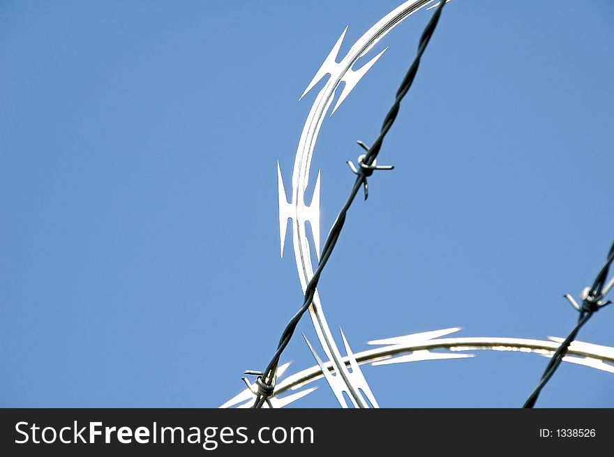 Close-up of razor wire security fence in bright sun