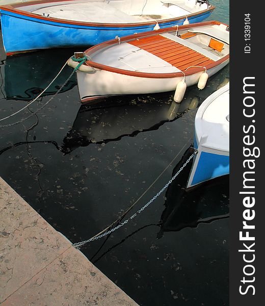 A closeup of three boats on the Lake Garda (Italy)