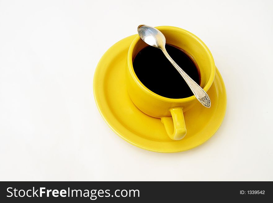 Yellow cup of tea isolated on white