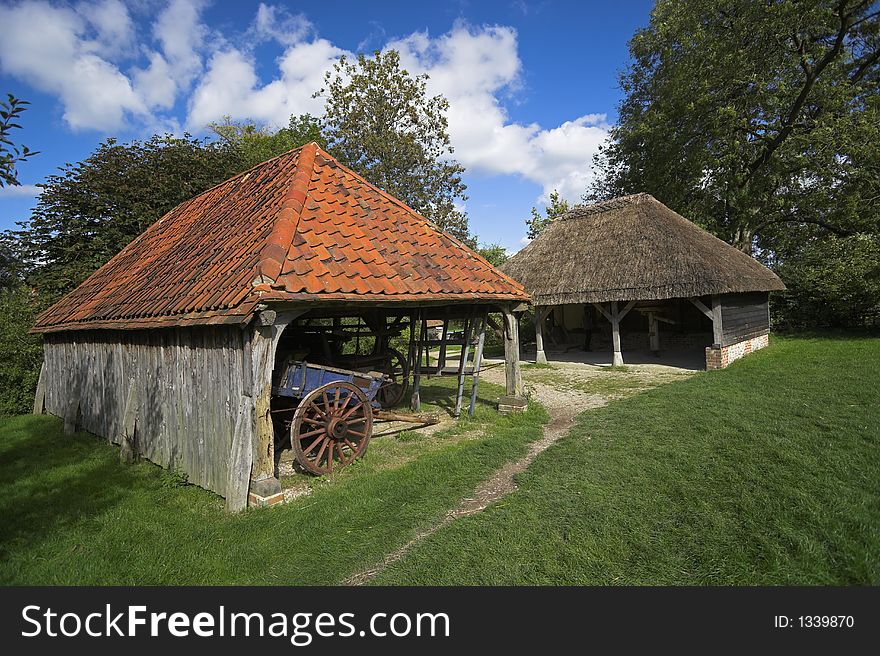 Tudor Barn on farm with tiled and thatched roofs. Tudor Barn on farm with tiled and thatched roofs