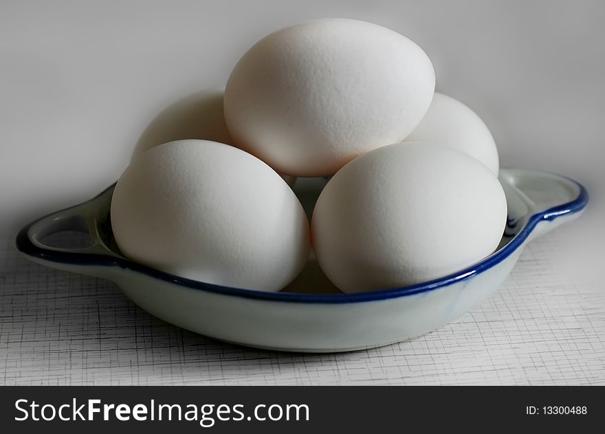 Five white eggs on a plate. Five white eggs on a plate