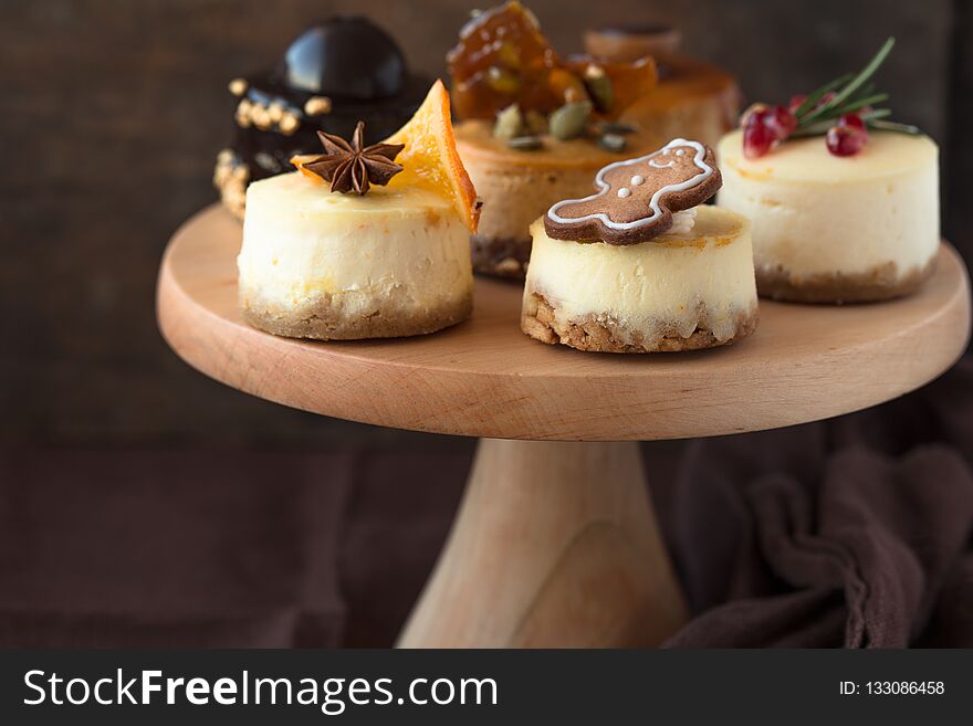 Heaps of various cheesecake is one type of chocolate cake. Vintage tone. Christmas orange cheesecake with mascarpone. Festive Christmas cheesecake traditional winter cake recipe . caramel Cheese cake whole