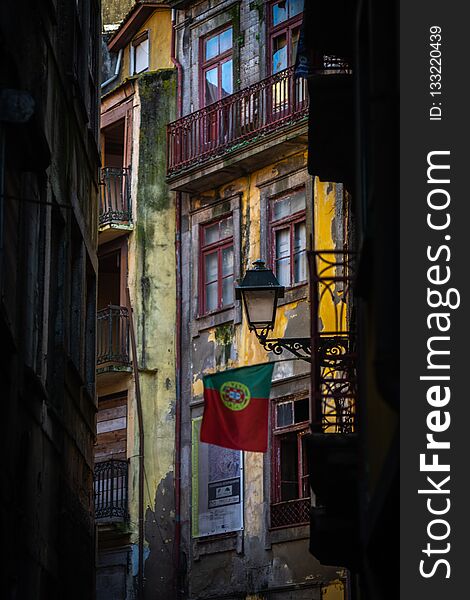 Portugal flag on the street of porto with colorfull house in the background vertical