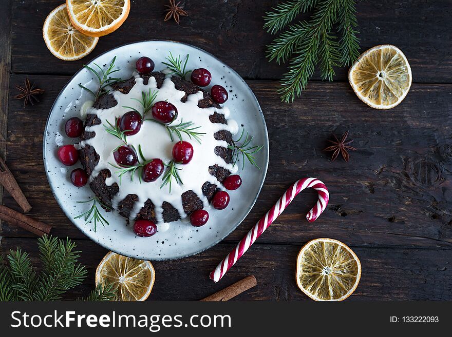 Christmas Pudding, Fruit Cake decorated with icing and cranberries on rustic wooden table, top view. Homemade traditional christmas dessert - Christmas Pudding