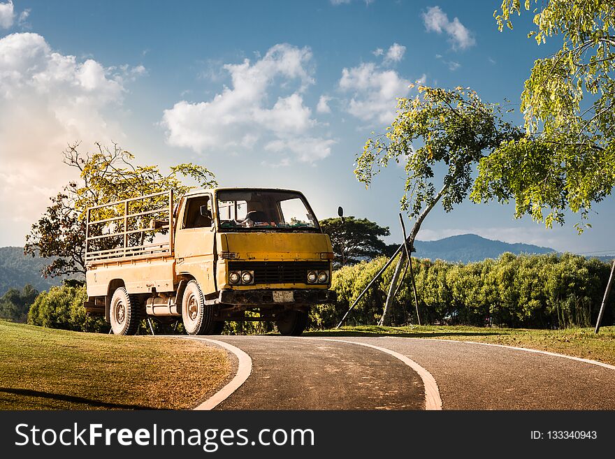 Old Yellow Small Truck On The Street In The Park