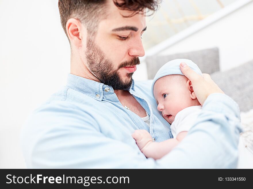 Loving father with baby in his arms