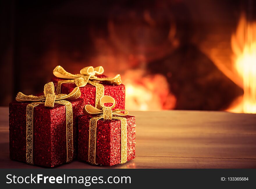 Christmas decoration on wooden table with blurred fireplace in the background. Christmas decoration on wooden table with blurred fireplace in the background.