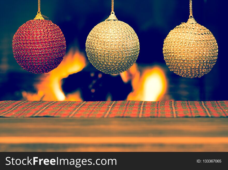 Christmas decoration on wooden table with blurred fireplace in the background. Christmas decoration on wooden table with blurred fireplace in the background.