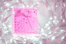 Pink Gift Box With A Bow And Hearts On A Silver Blurred Background Royalty Free Stock Image