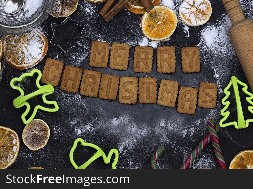 Baking concept background with spices and utensils for Christmas cookies. Christmas food. Ingredients for cooking. Christmas baking.kitchen utensils and dried fruits on a dark table top view