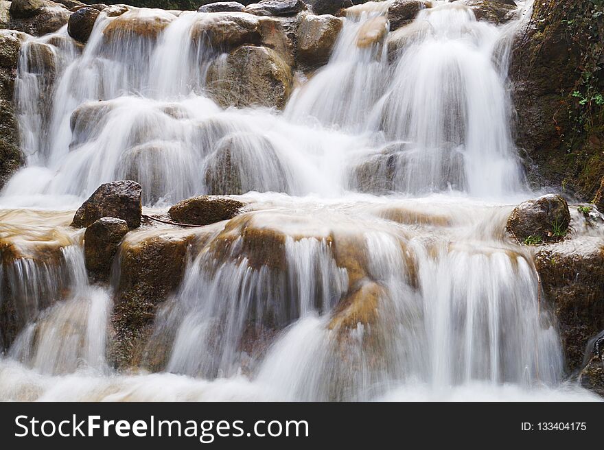 Waterfall photography with long time exposure making foggy landscape out of flowing water. Waterfall photography with long time exposure making foggy landscape out of flowing water