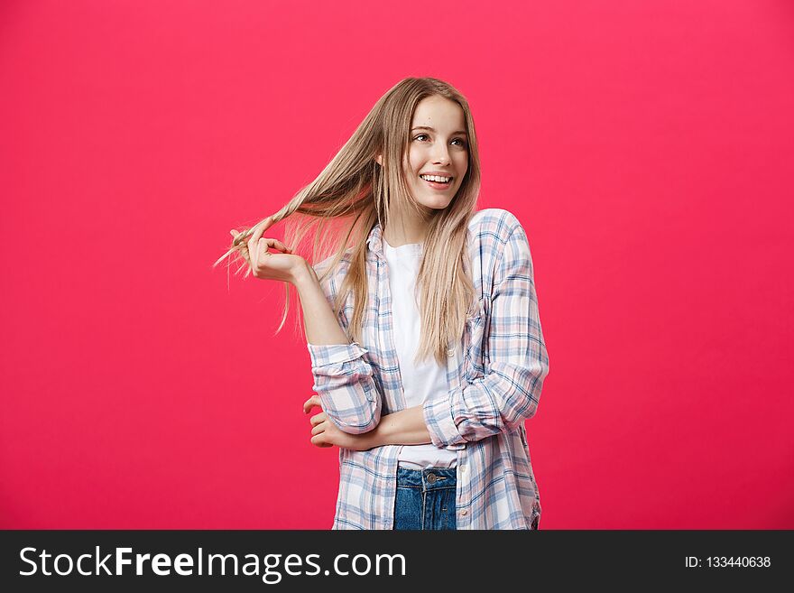 Smiling beautiful woman portrait with crossed arms on pink background