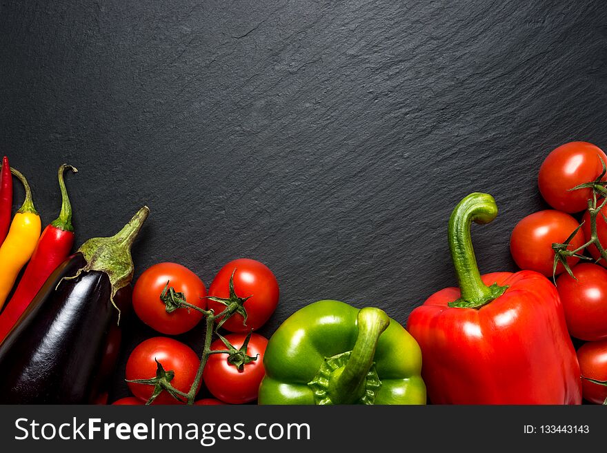 Colorful vegetables for healthy diet on black background with copy space