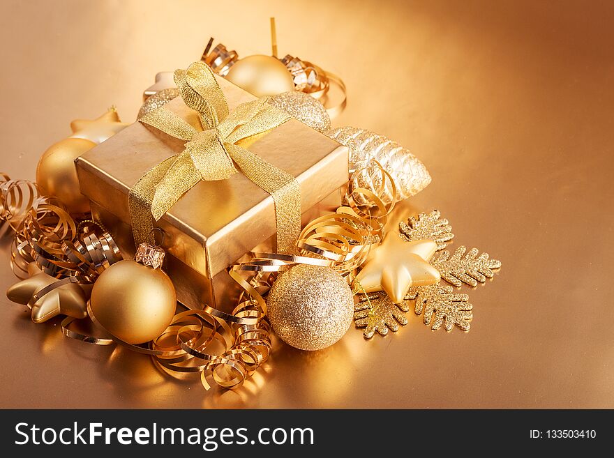 Christmas composition of Christmas tree toys on a blurred gold background.