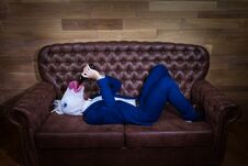 Funny Unicorn In Elegant Suit Lies On Sofa Stock Photography